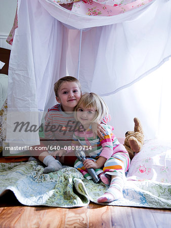 brother and sister in a makeshift fort