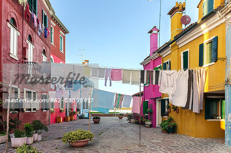 Italy, Veneto, Venice, Burano. Clothes hanging out to dry in the streets