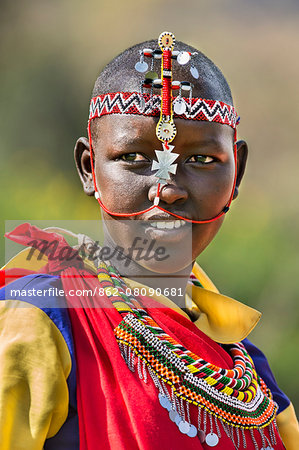 Kenya, Samburu County, Bawa. A Samburu schoolgirl from Ler Primary School dresses in typical tribal finery while competing in a schools'  cultural display.