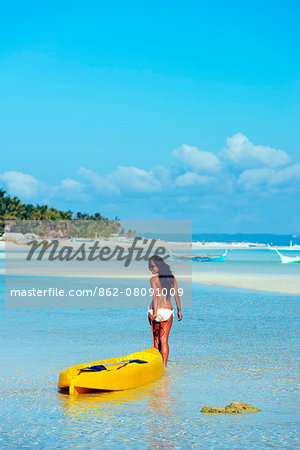 South East Asia, Philippines, The Visayas, Cebu, Bantayan Island, Paradise Beach, girl with a kayak (MR) South East Asia, Philippines, The Visayas, Cebu, Bantayan Island, Paradise Beach, girl with a kayak (MR)