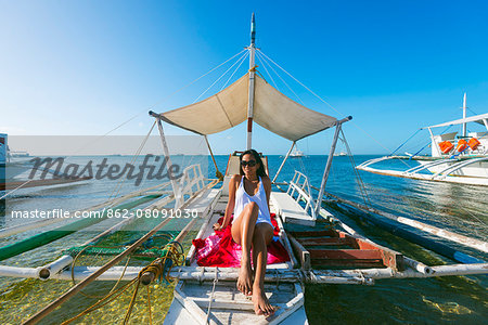 South East Asia, Philippines, The Visayas, Cebu, Malapascua island, girl aboard a catamaran, Bounty beach (MR)