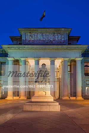 Night view of the facade of Museo del Prado with bronze statue of spanish painter Diego Velazquez, Madrid, Comunidad de Madrid, Spain