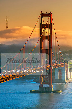 Sunset view over the Golden Gate with fog in the background, San Francisco, California, USA