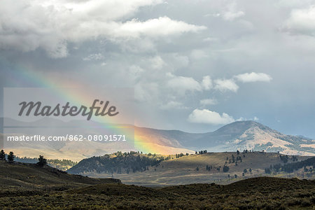 USA, Wyoming,  Yellowstone National Park, UNESCO, World Heritage, rainbow during thundersorm over the Gardner valley