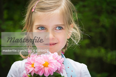 Girl gardening, holding flowers