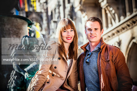Portrait of happy young couple on Marienplatz, Munich, Bavaria, Germany