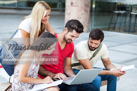 Group of students working together on laptop