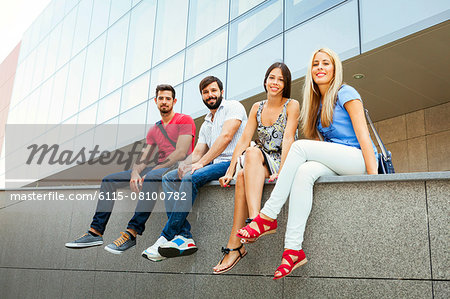 Group of university students sitting on campus
