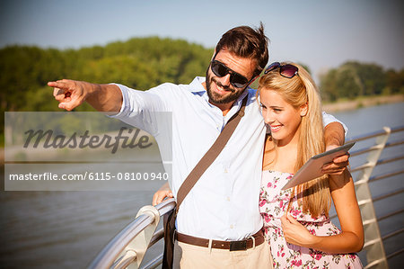 Young couple with digital tablet on sightseeing tour