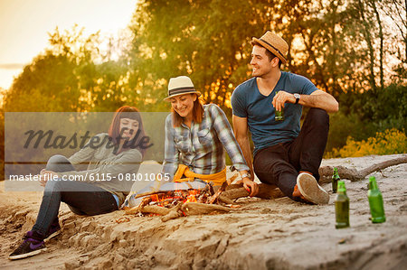 Group of friends relaxing by campfire, Osijek, Croatia