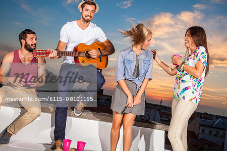 Young people having fun at rooftop party