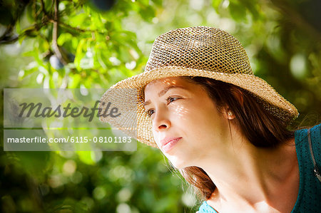 Portrait of young woman with straw hat