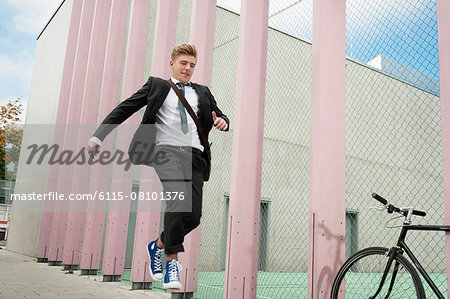 Young businessman jumping in air, Munich, Bavaria, Germany