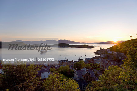 View over Oban Bay from McCaig's Tower, sunset, ferry coming into port, Oban, Argyll and Bute, Scotland, United Kingdom, Europe