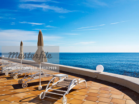 Sunbeds and Closed Sunshades on Deck at Hotel, Cala Ratjada, Majorca, Balearic Islands, Spain