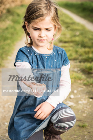 Girl holding worm in hand