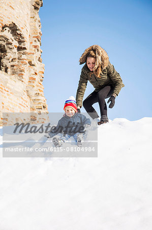 Mother playing with son in snow