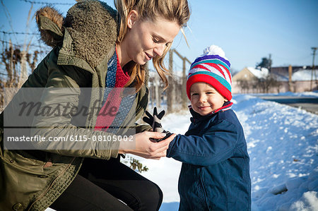 Mother and son in snowy landscape