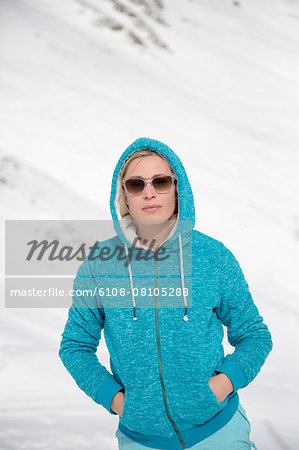 Beautiful woman standing in snow, Crans-Montana, Swiss Alps, Switzerland