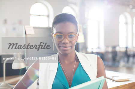 Portrait confident businesswoman wearing eyeglasses in office