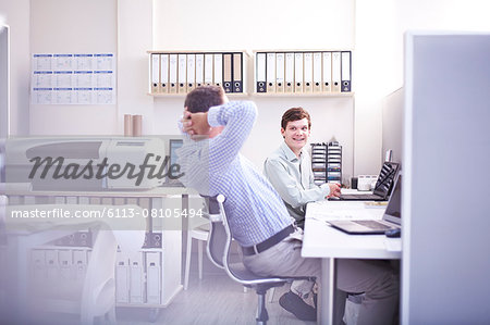 Architects talking at desk in office