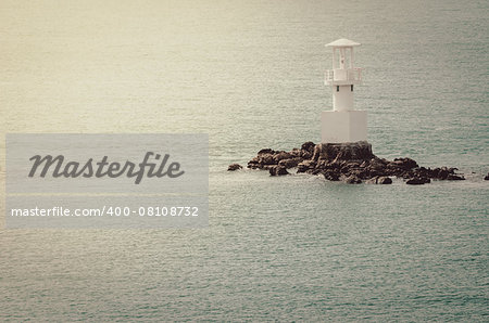 White Lighthouse on the sea and blue sky in Thailand vintage