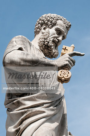 Saint Peter with Eden key against the blue sky background. The close-up of sculpture near St. Peter's Basilica.