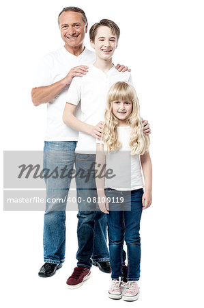 Smiling father, son and daughter posing to camera