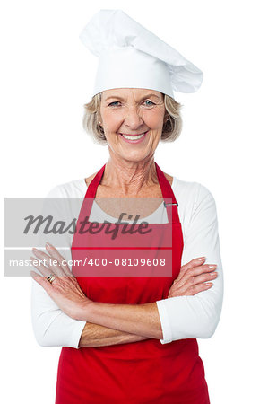 Confident aged woman chef smiling over white