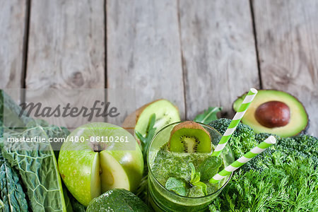 Green detox smoothie with raw vegetables and fruits. Copyspace background.