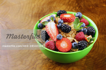 homemade granola muesli with berries (strawberries, raspberries, blueberries) for breakfast