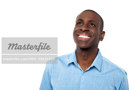 smiling man in casual clothing looking up