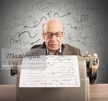 Old man writes his projects with typewriter