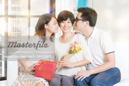 Happy mothers day. Asian boy and girl kissing mother. Family living lifestyle at home.