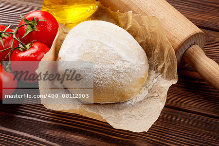 Pizza cooking ingredients. Dough, tomatoes and olive oil. Top view with copy space