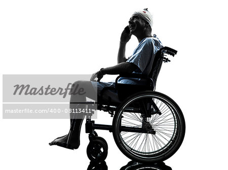 one injured man on the telephone happy in wheelchair in silhouette studio on white background