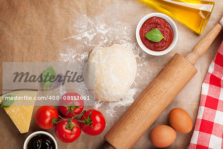 Pizza cooking ingredients. Dough, vegetables and spices. Top view with copy space