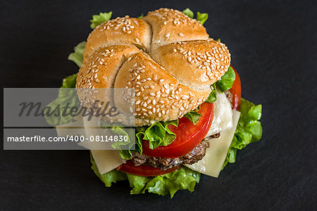 Closeup of Homemade Hamburger with Fresh Vegetables on Stone Background