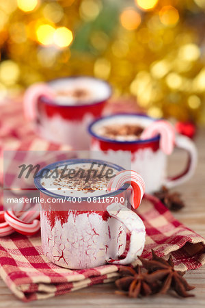 Christmas decorated cups with hot chocolate for holidays. Focus on candycane.