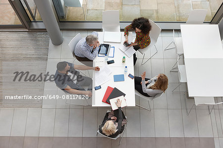 Overhead view of business team having meeting at conference table