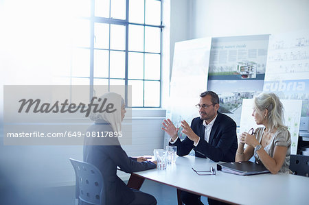 Business team discussing presentation ideas in conference room