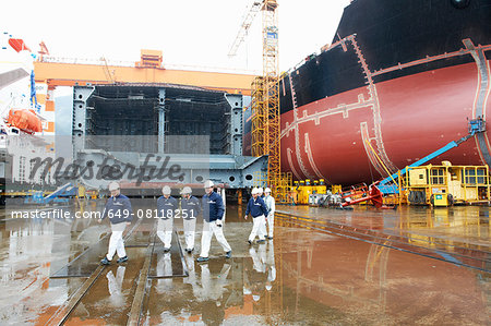 Workers walking across shipyard, GoSeong-gun, South Korea