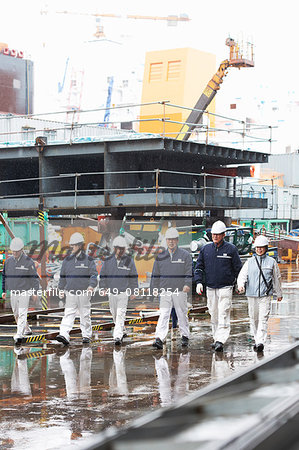 Workers walking across shipyard, GoSeong-gun, South Korea