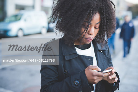 Young woman texting on smartphone, Lake Como, Como, Italy