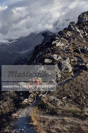 Mountain biker on dirt track, Valais, Switzerland