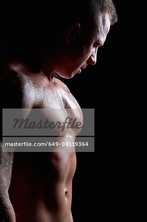 Muscular young man side lit