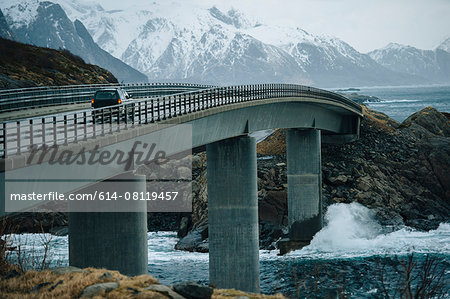 Off road vehicle crossing coastal bridge, Reine, Lofoten, Norway