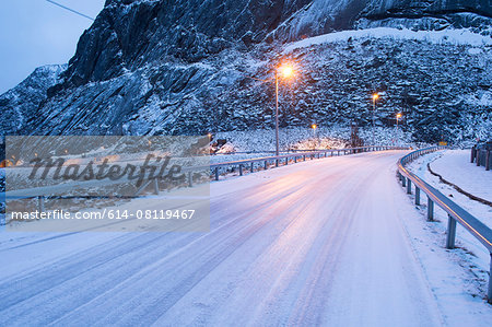 Snow covered highway at dusk, Reine, Lofoten, Norway