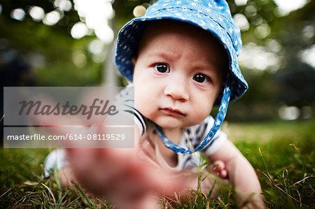 Close up of baby boy reaching out towards camera