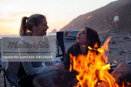 Girlfriends having barbecue on beach, Malibu, California, USA